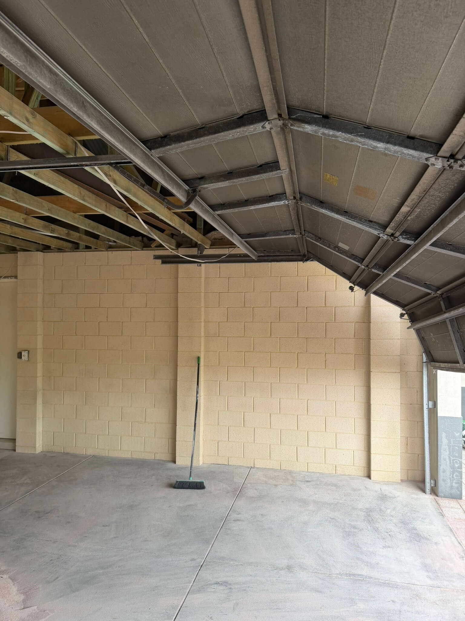 The same garage with soot and char removed from the block walls, ceiling sheeting and roof steel