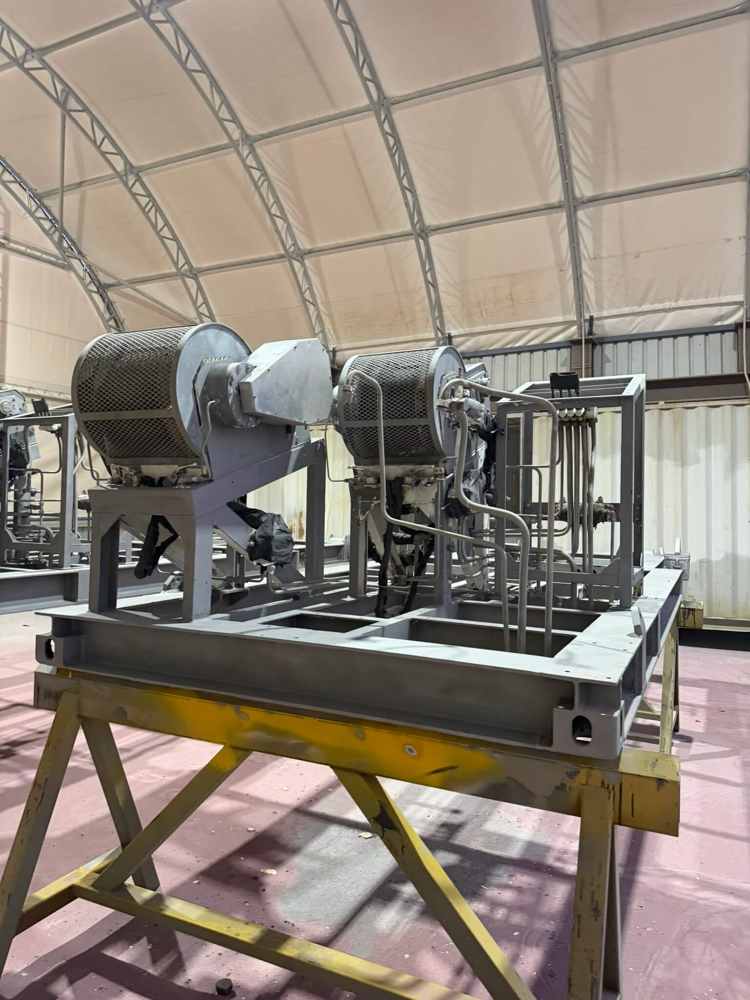 The same machinery skid blasted back and primed in grey, frames and drum housings included