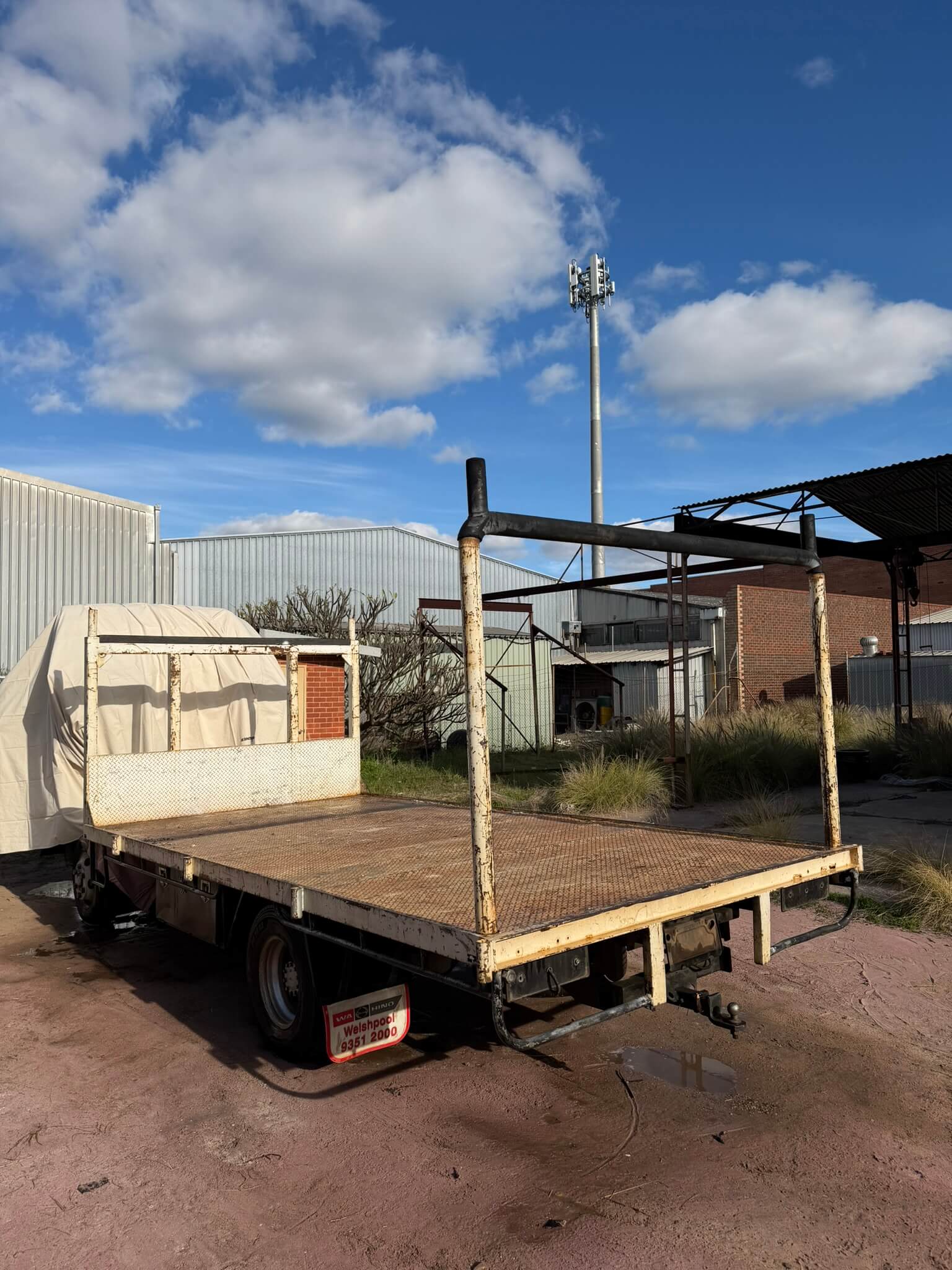 Truck tray and rear gantry with failed cream paint and rust before sandblasting