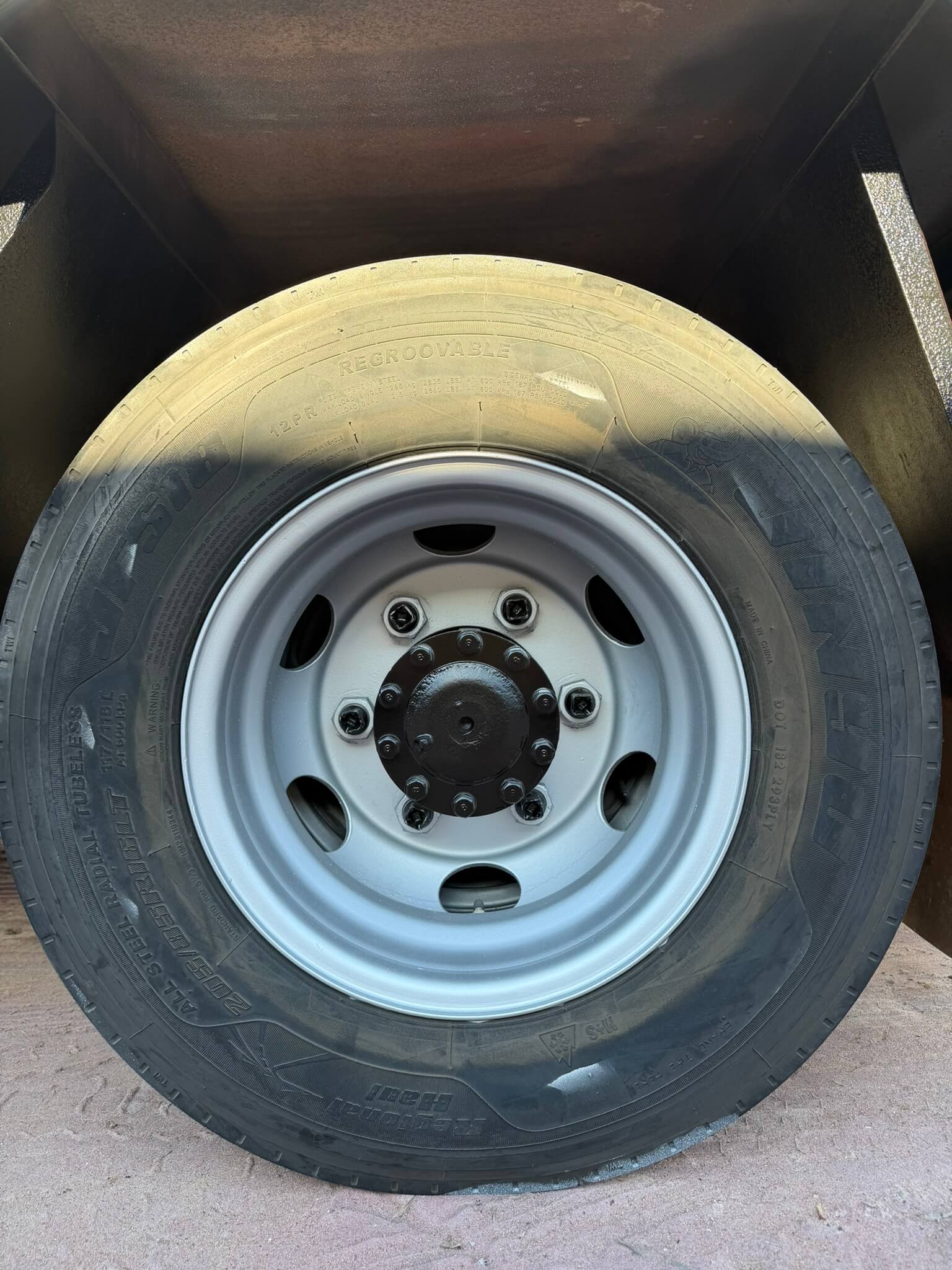 The same truck wheel blasted and coated in silver with the hub cap and nuts in black
