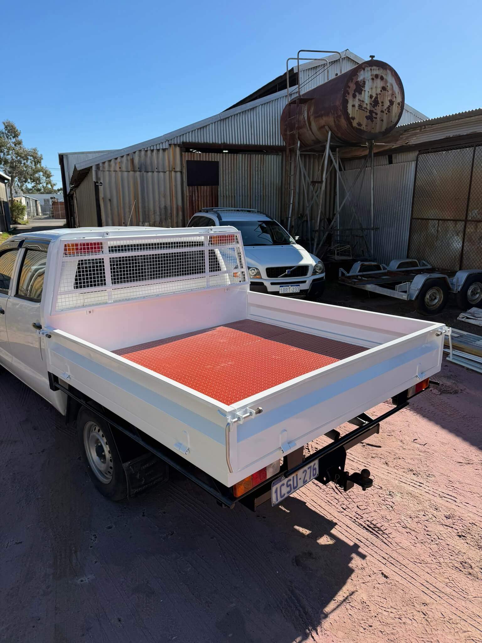 The same ute tray blasted, primed and finished in white two-pack with a recoated checker-plate floor