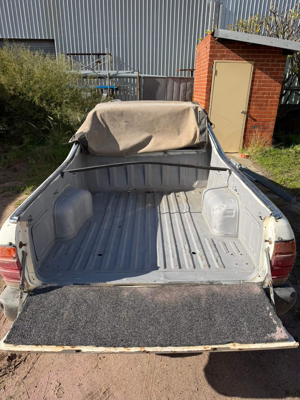 The same ute tub blasted back to clean steel and held in grey primer ready for topcoat