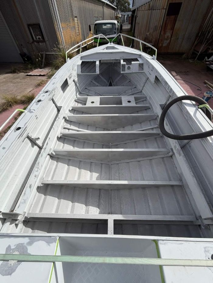 Aluminium boat hull interior sandblasted back to clean metal in WA