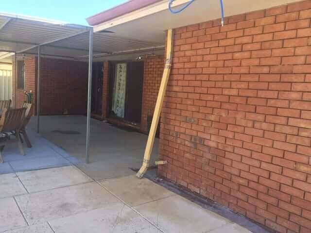Brick patio and carport walls cleaned back to face brick