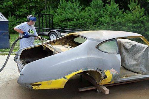 Full car body shell blasted to bare metal without warping the panels