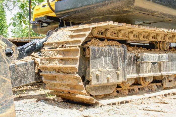 Excavator undercarriage and tracks cleaned before coating