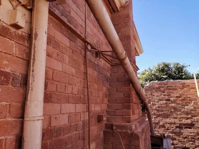 Render being removed from brickwork with wet abrasive blasting in Perth