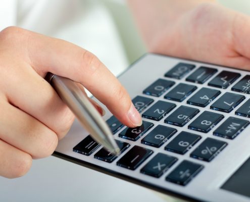 Dustless Blasting Prices - portrait of woman with a calculator and pen