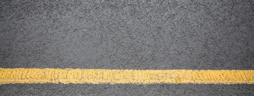 Line Marking - two yellow lines painted on asphalt road